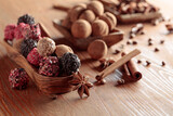Chocolate truffles on a wooden table.