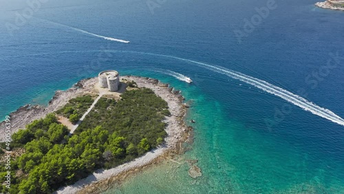 Castle on the island of Otocic Gospa in the Bay of Kotor. Montenegro. Top view of the island with a fortress. Drone. Pleasure boats in the bay. 
 photo