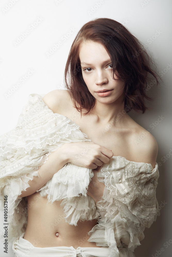 Angelic beauty. Portrait of a beautiful young woman semi-clad with a lace shawl wrapped around her. Angelic beauty. Portrait of a beautiful young woman semi-clad with a lace shawl wrapped around her.
