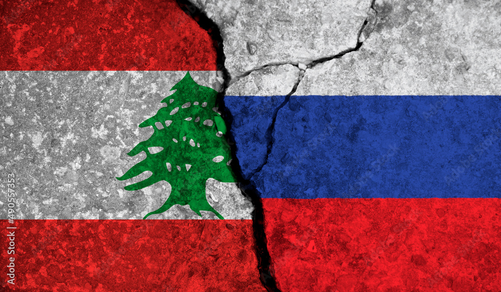 Political relationship between Lebanon and russia. National flags on cracked concrete background