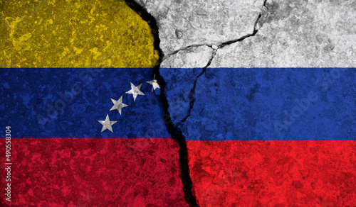 Political relationship between Venezuela and russia. National flags on cracked concrete background