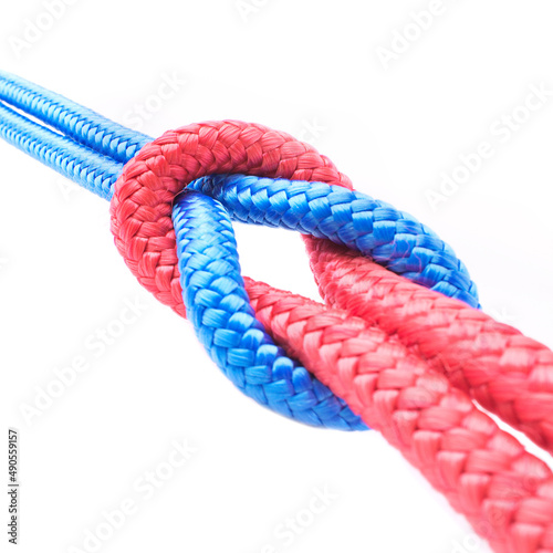 Tied together. Studio shot ropes knotted together isolated on white.