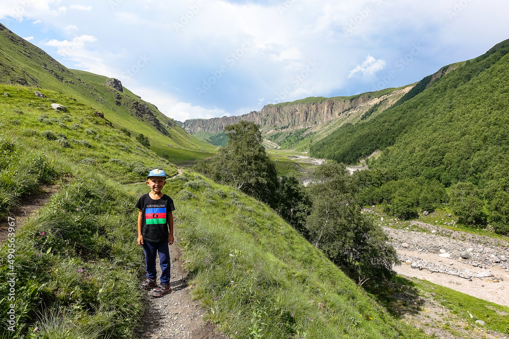 Boy at the Kyzyl-Kol River, surrounded by the Caucasus Mountains near Elbrus, Jily-su, Russia