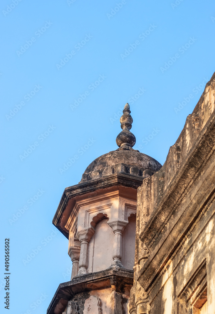 Aged mossy dome of a mosque under the clean blue sky with copy space