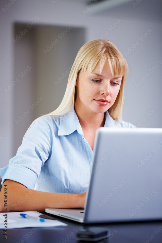Working hard on presentation. Young business woman busy with her work on laptop. Working hard on presentation. Young business woman busy with her work on laptop.