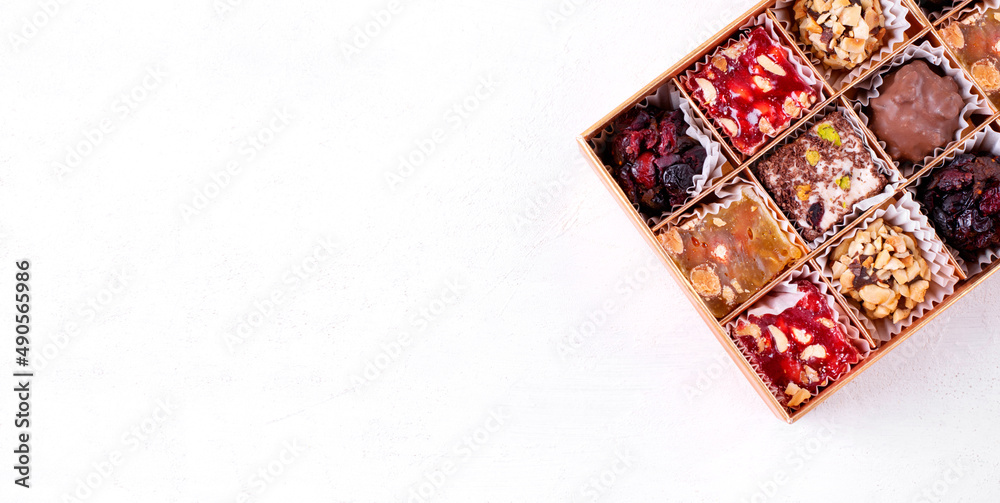 Web banner with Turkish delight sweets in the box. Colorful confectionery variation. Eastern dessert. Mockup with copy space on white background Web banner with Turkish delight sweets in the box. Colorful confectionery variation. Eastern dessert. Mockup with copy space on white background