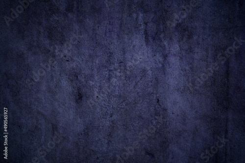 Grunge textured dark purple concrete wall surface for background