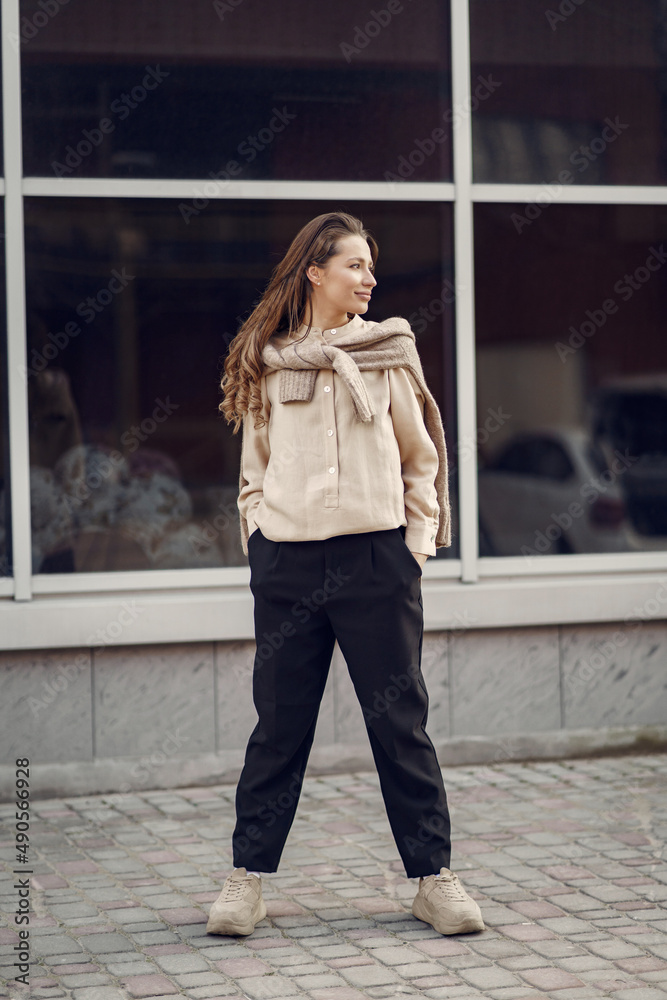 Elegant woman in a brown shirt in a spring city Elegant woman in a brown shirt in a spring city