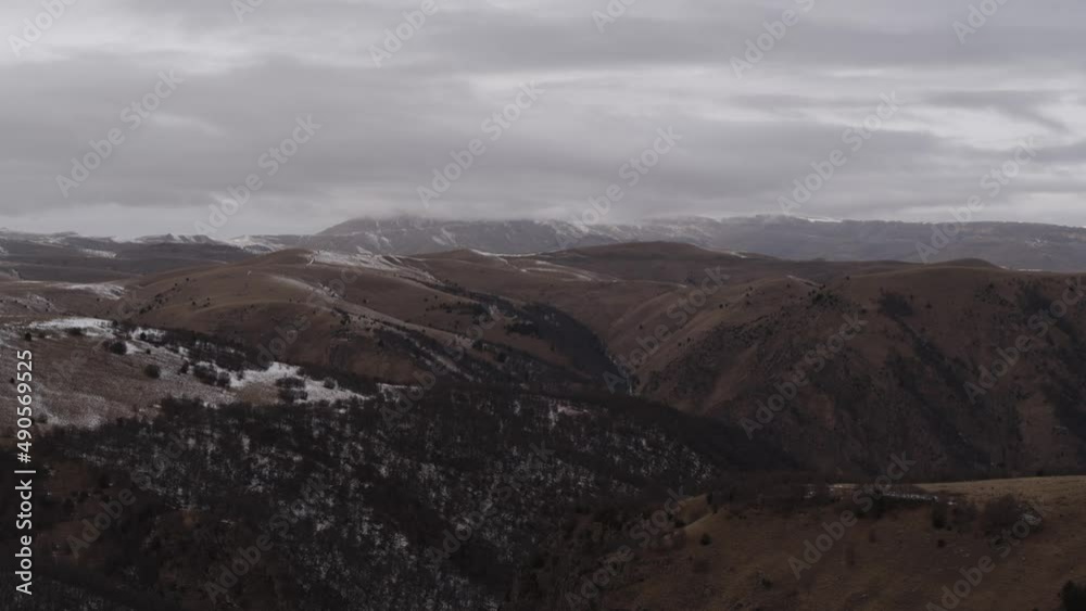 Car in the mountains of the Caucasus in winter. An electric car drives through winter landscapes. Flights on the copter, tracking the car from the side to the rear and three-quarters. General plans. Car in the mountains of the Caucasus in winter. An electric car drives through winter landscapes. Flights on the copter, tracking the car from the side to the rear and three-quarters. General plans.