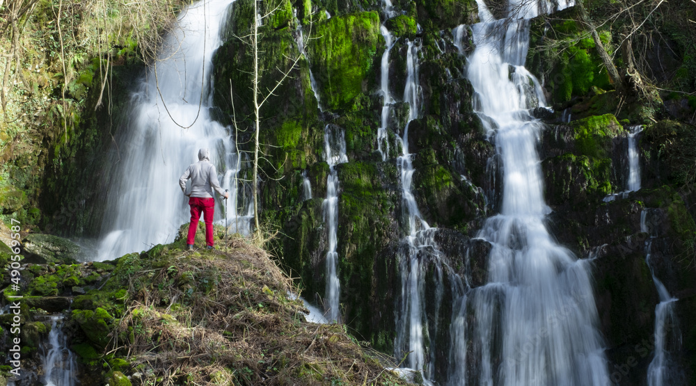 Mountaineer at a waterfall in the Araitz valley, Navarra, Spain Mountaineer at a waterfall in the Araitz valley, Navarra, Spain