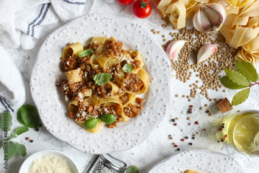 Pappardelle pasta with lentil ragout on light background. Vegan and vegetarian food. Top view. Pappardelle pasta with lentil ragout on light background. Vegan and vegetarian food. Top view.