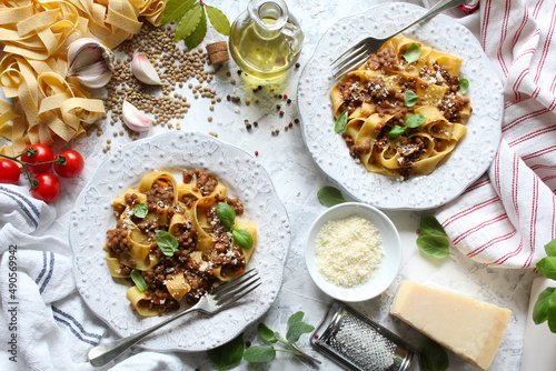 Pappardelle pasta with lentil ragout on light background. Vegan and vegetarian food. Top view.
