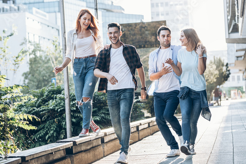 Young friends hang out on the city street.They go for walks together and have fun in the city downtown.
 photo