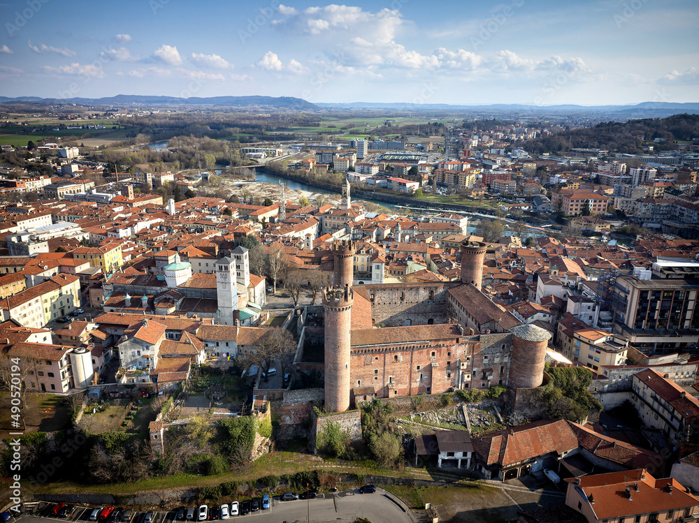 Aerial view of the historic centre with the Castle with its red towers in the foreground. Ivrea, Italy - March 2021