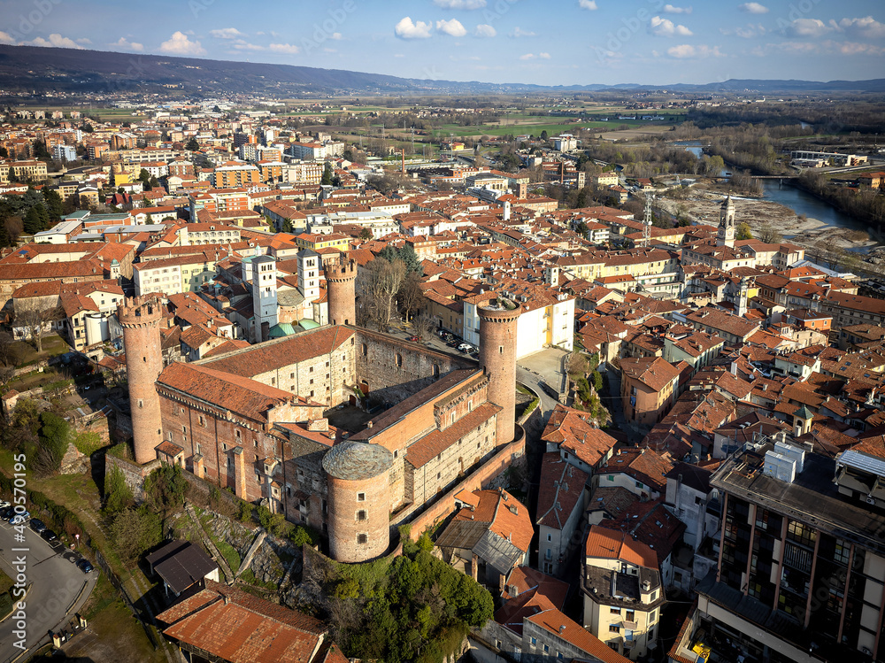 Aerial view of the historic centre with the Castle with its red towers in the foreground. Ivrea, Italy - March 2021 - obrazy, fototapety, plakaty 