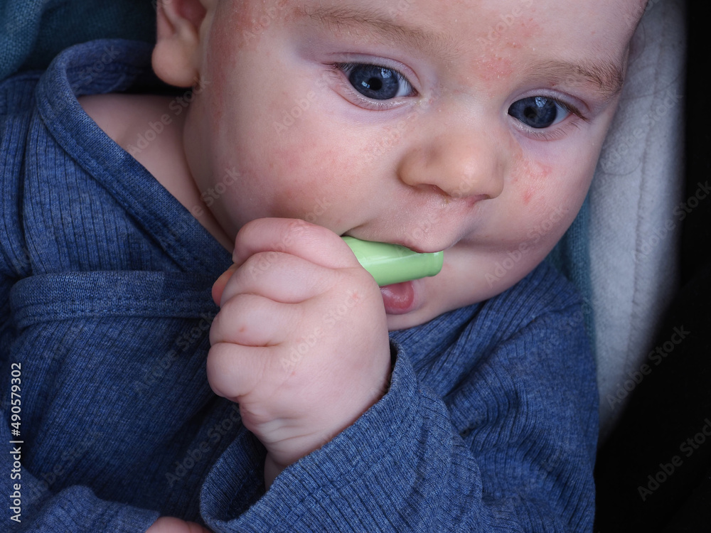 baby holds in his hands and pulls an electric battery into his mouth baby holds in his hands and pulls an electric battery into his mouth