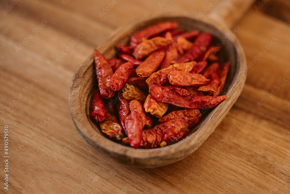 Red cayenne pepper. Red chili on wooden spoon. Red cayenne pepper. Red chili on wooden spoon.