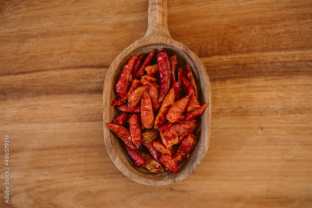 Red cayenne pepper. Red chili on wooden spoon. Red cayenne pepper. Red chili on wooden spoon.