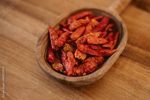 Red cayenne pepper. Red chili on wooden spoon. 