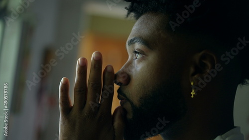 A spiritual African man worshiping God praying with HOPE and FAITH