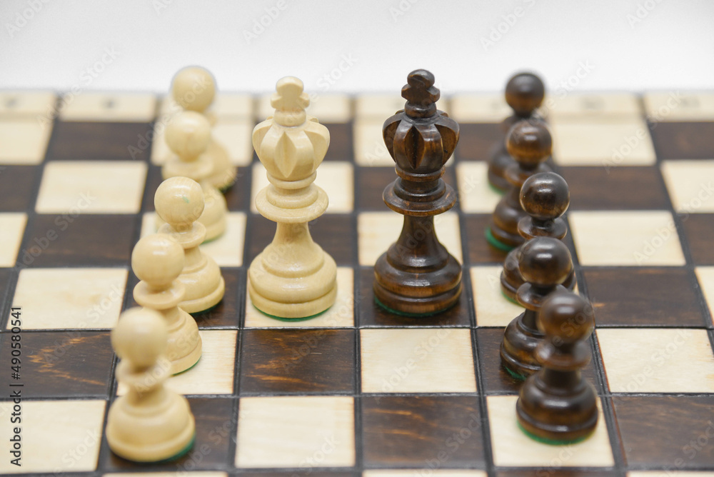 Black and white wooden figures for chess on the board Black and white wooden figures for chess on the board