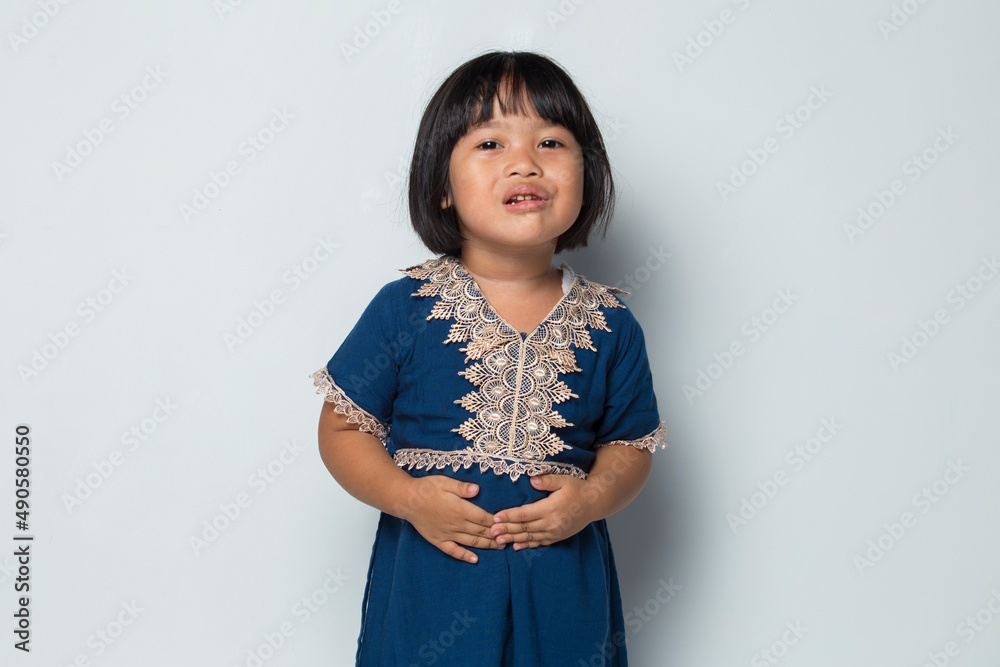 little asian girl having a stomach ache isolated on white background little asian girl having a stomach ache isolated on white background
