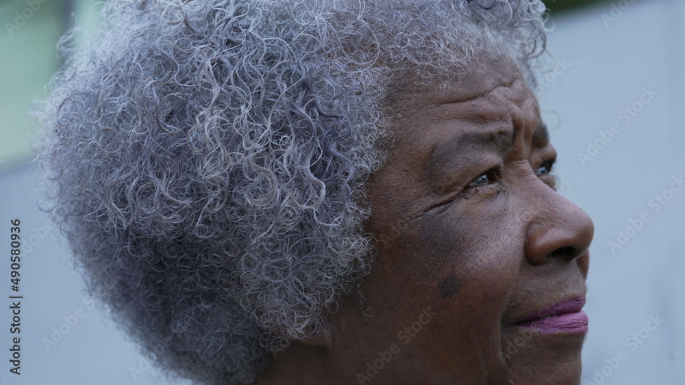 A meditative senior woman portrait face closeup in contemplation
