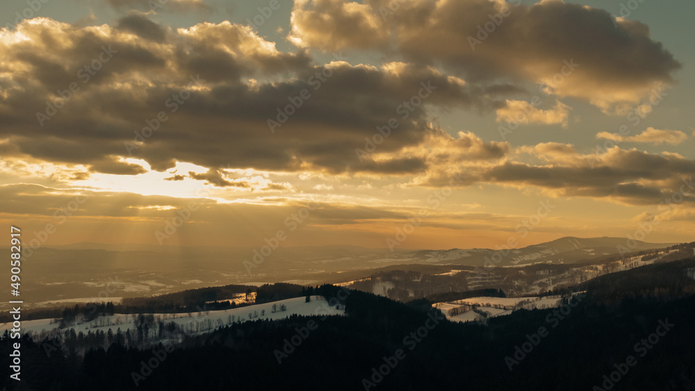 Winter forest, sky with clouds at sunset
