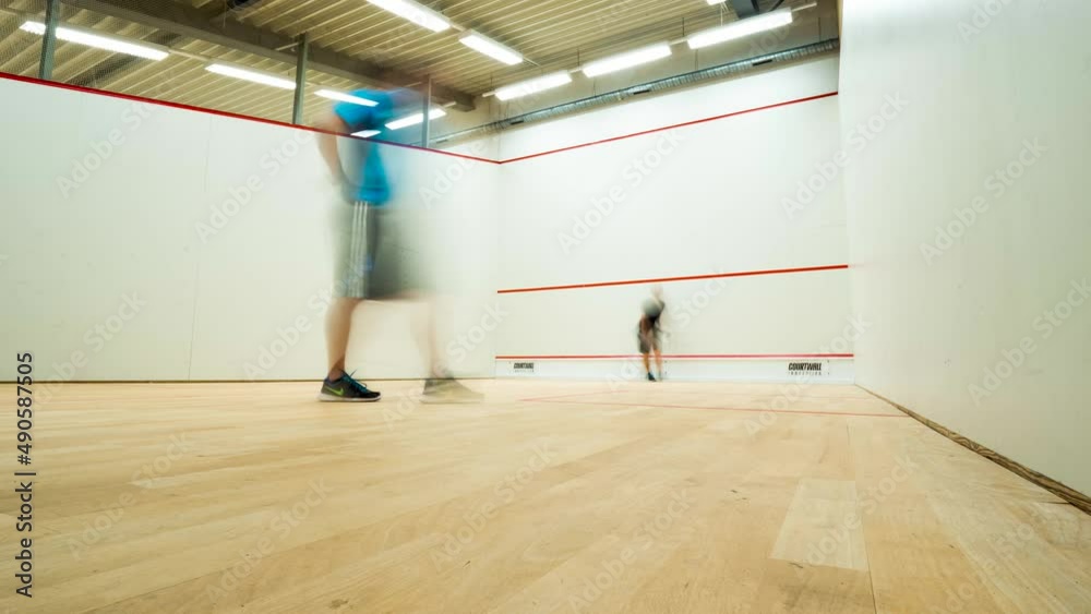 Time lapse two beginner squash player playing a game squash static shot