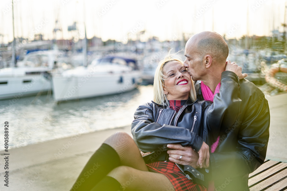 Romantic middle-aged couple embracing the marina