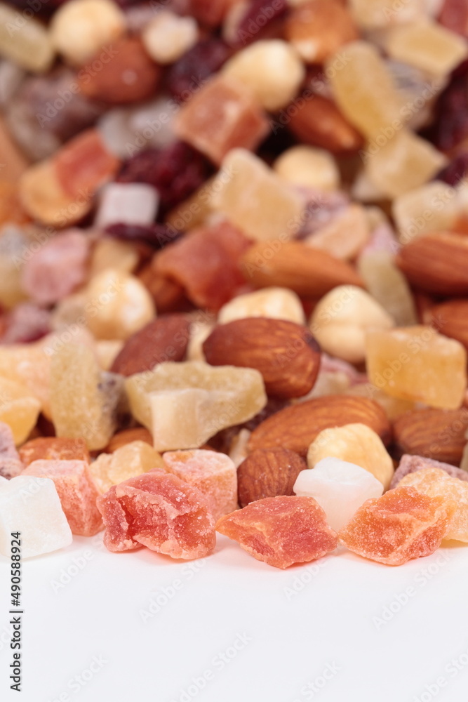 Healthy dried fruits and nuts on a white background.