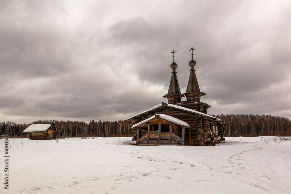 Russian wooden architecture in the snow in winter