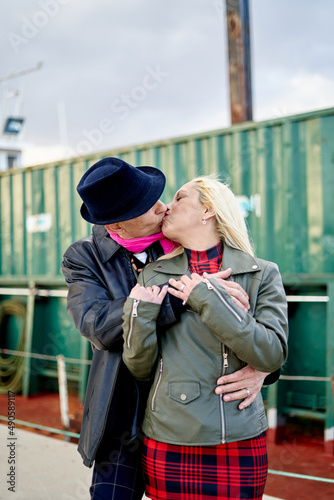 Romantic middle-aged couple kissing in the harbor