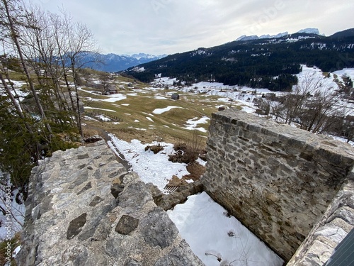 Castle ruins Wildenburg or Burgruine Wildenburg (Ruine Wild Huus) over the alpine valley Obertoggenburg, Wildhaus - Canton of St. Gallen, Switzerland (Schweiz) photo