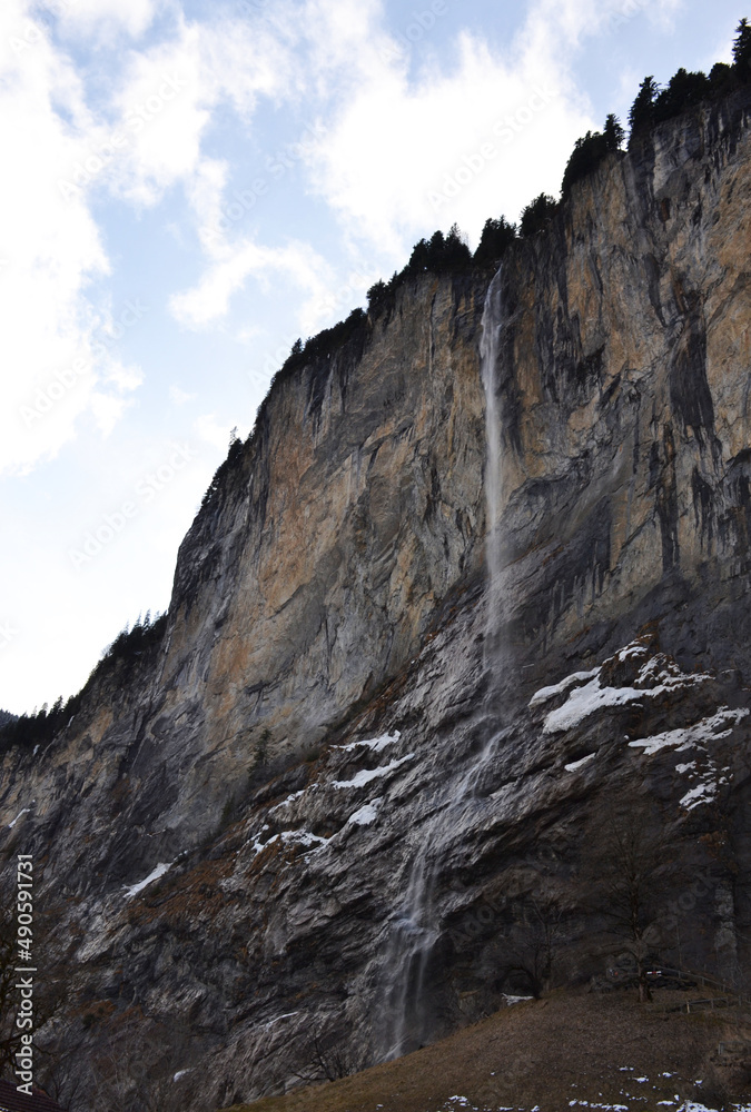 Staubbach waterfall during winter time in Lauterbrunnen village, Switzerland
