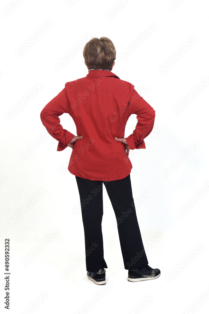 Fototapeta premium rear view of a senior woman hands on hip on white background