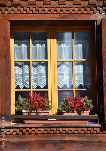 Old style open windows of a house in a swiss village