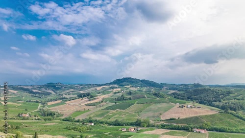view of green summer valley of italian coyntryside timelapse with hills on background photo