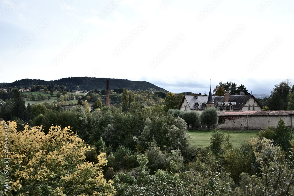 Coubon, France - october 11th 2019 : Focus on a building that looks like a cosy, rural mansion, or a small castle. It is in the middle of nature, in a volcanic region. It's a perfect cottage.