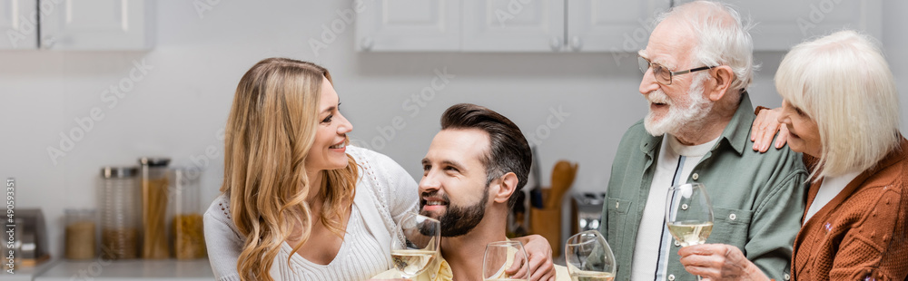 joyful family holding wine glasses while celebrating easter at home, banner. joyful family holding wine glasses while celebrating easter at home, banner.