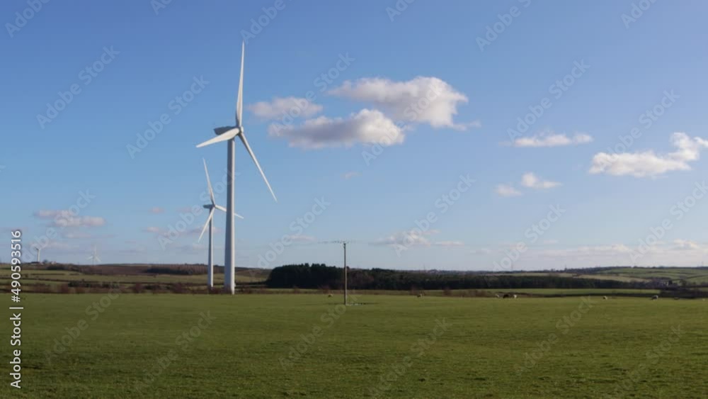 Wind turbine for green energy rotating in sunshine. Wind turbine for green energy rotating in sunshine.