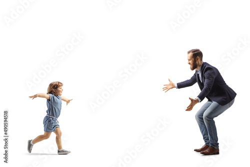 Full length profile shot of a little girl running to hug her father