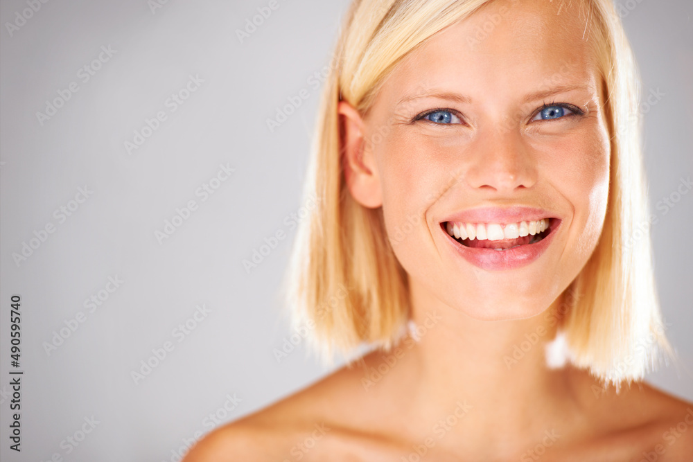 She will bring all the attention here - Copyspace. Portrait of a pretty young woman with a large grin and copyspace beside her. She will bring all the attention here - Copyspace. Portrait of a pretty young woman with a large grin and copyspace beside her.