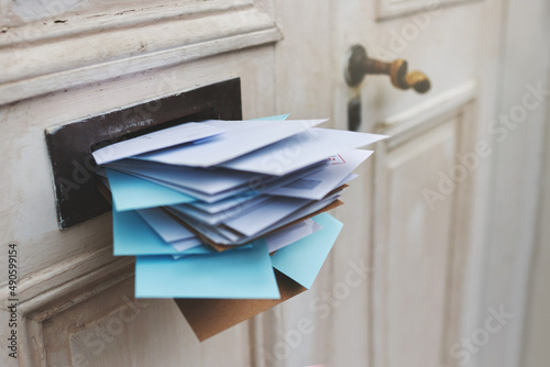 Jam-packed with the post. Cropped shot of letters in a letter box. photo
