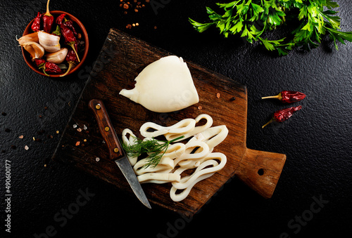 Slicing of boiled calamar on a cook-table photo