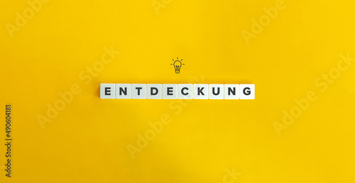 Entdeckung (Discovery in German) Word. Letter Tiles on Yellow Background. Minimal Aesthetics. photo