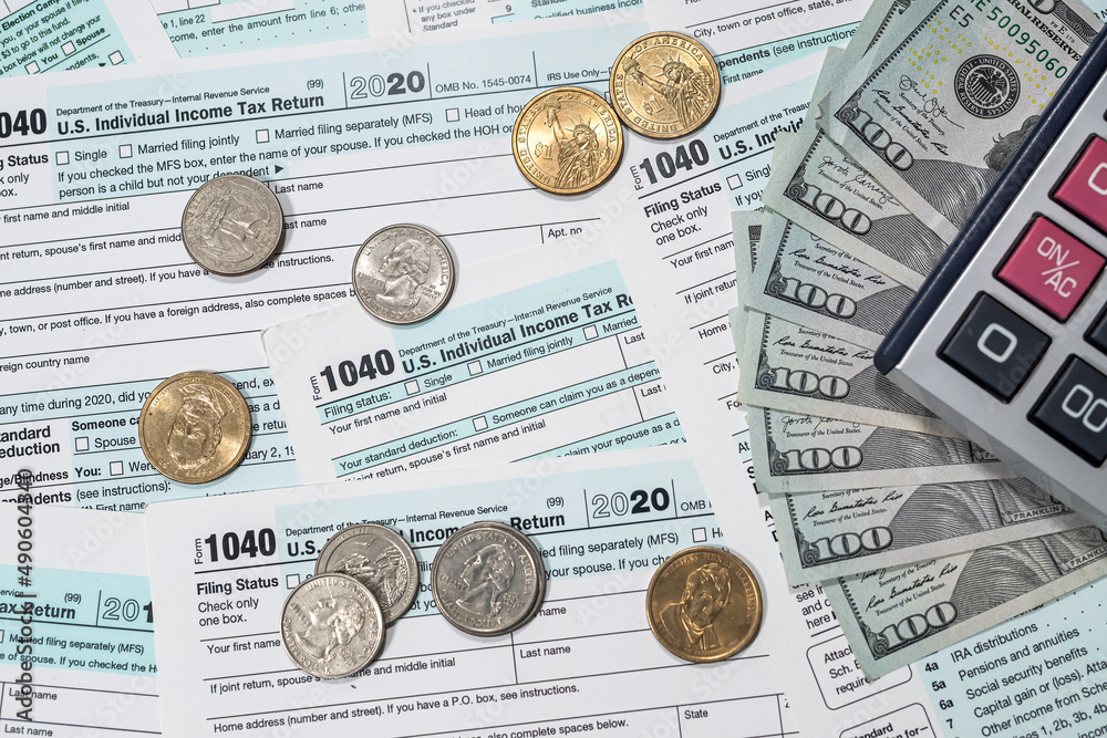 Financial document with dollar us 1040 tax form Financial document with dollar us 1040 tax form