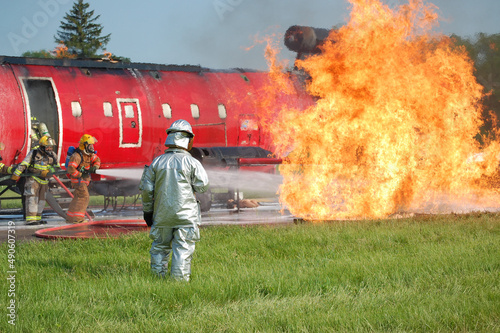 Firefighters attack airplane fire in training photo