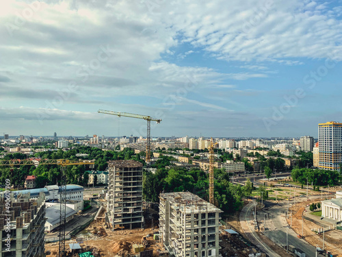 construction of a new neighborhood in the city. erection of new houses with a crane. high buildings for the life of people from concrete blocks