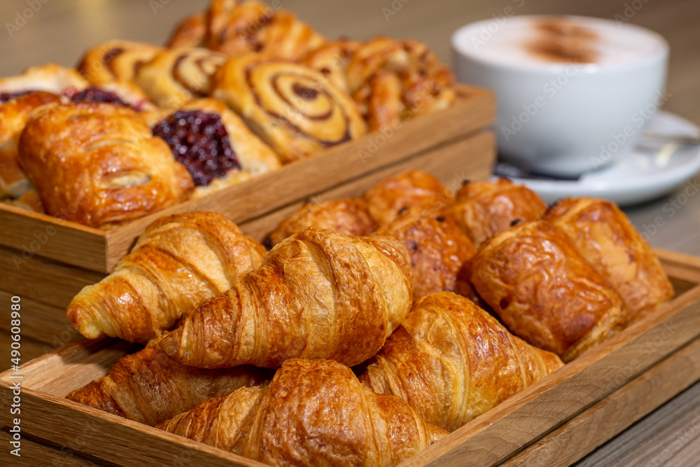 Continental breakfast of assorted pastries including croissants, cinnamon swirls and Danish breakfast pastries served with a cappuccino coffee Continental breakfast of assorted pastries including croissants, cinnamon swirls and Danish breakfast pastries served with a cappuccino coffee